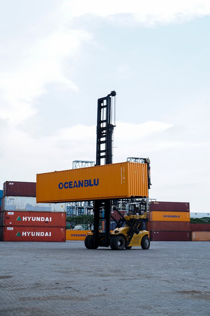 Crafting Captivating Headlines: Your awesome post title goes here Forklift handling container in bustling Jakarta port with clear skies.