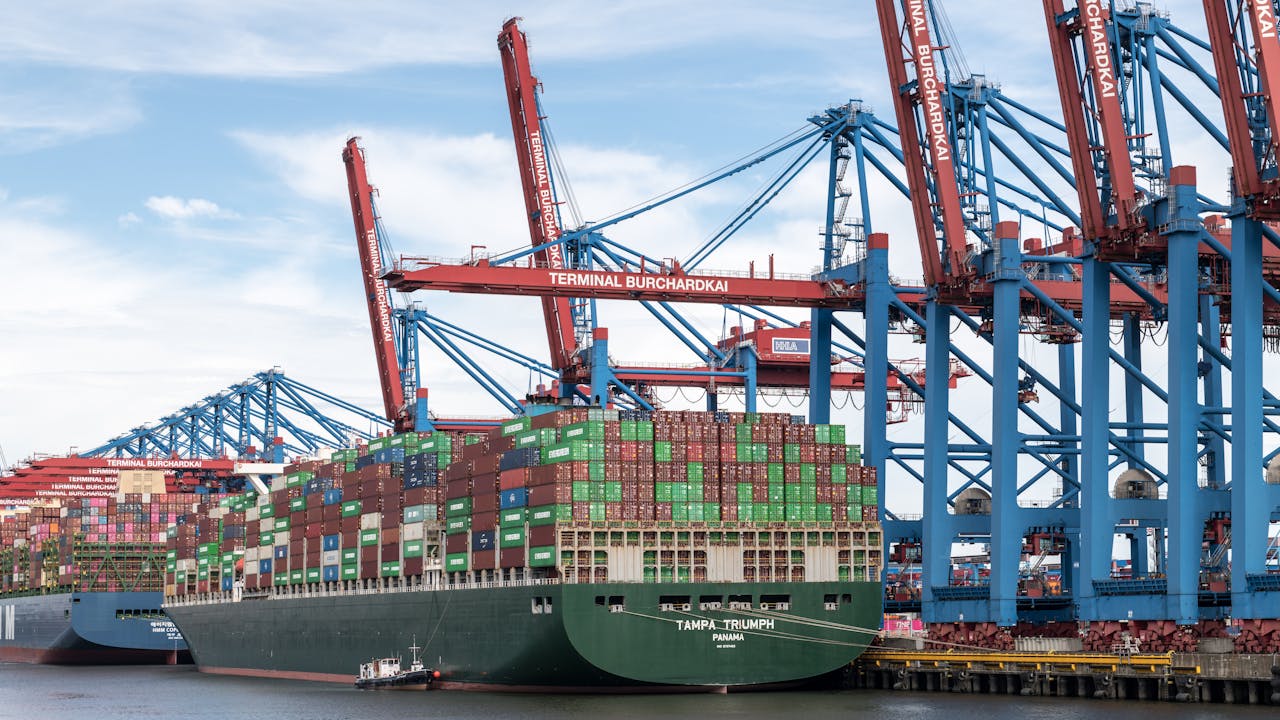 Mastering the First Impression: Your intriguing post title goes here A massive container ship docked at Terminal Burchardkai in Hamburg port, showcasing cargo handling.